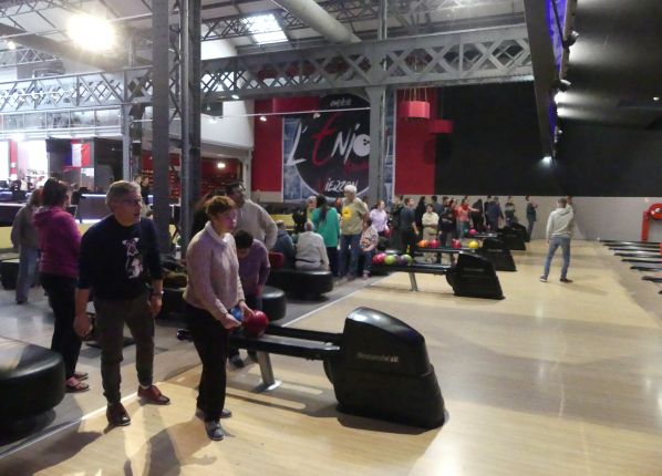 Un femme lance sa boule au bowling